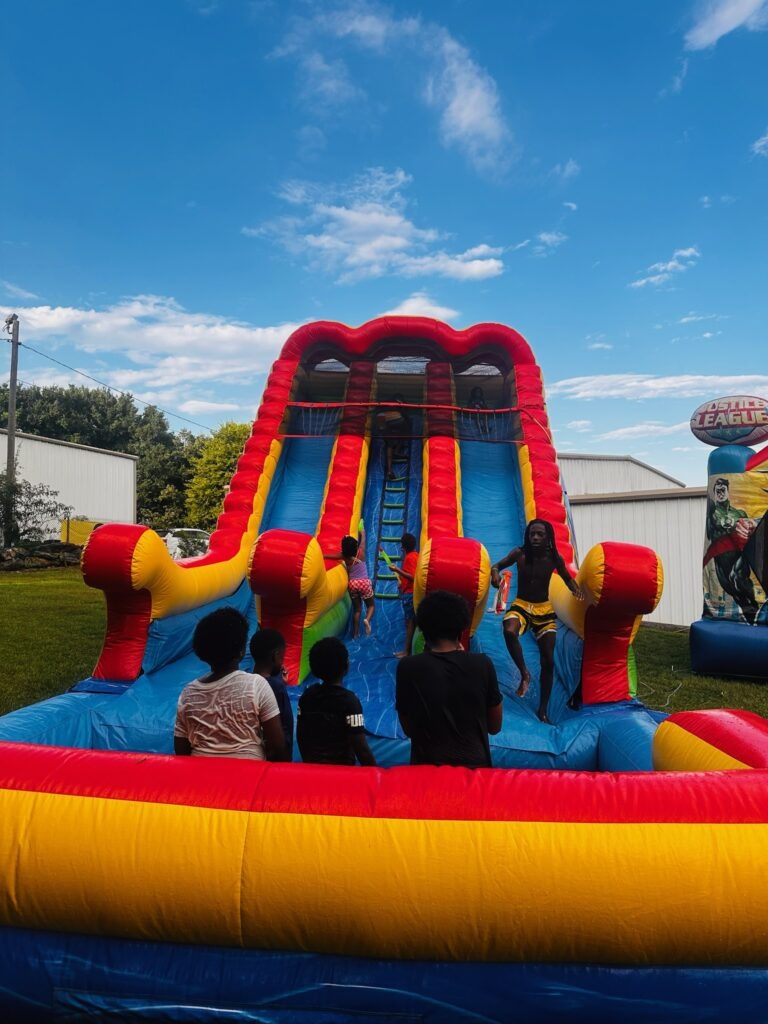 kids playing around justice league water slide