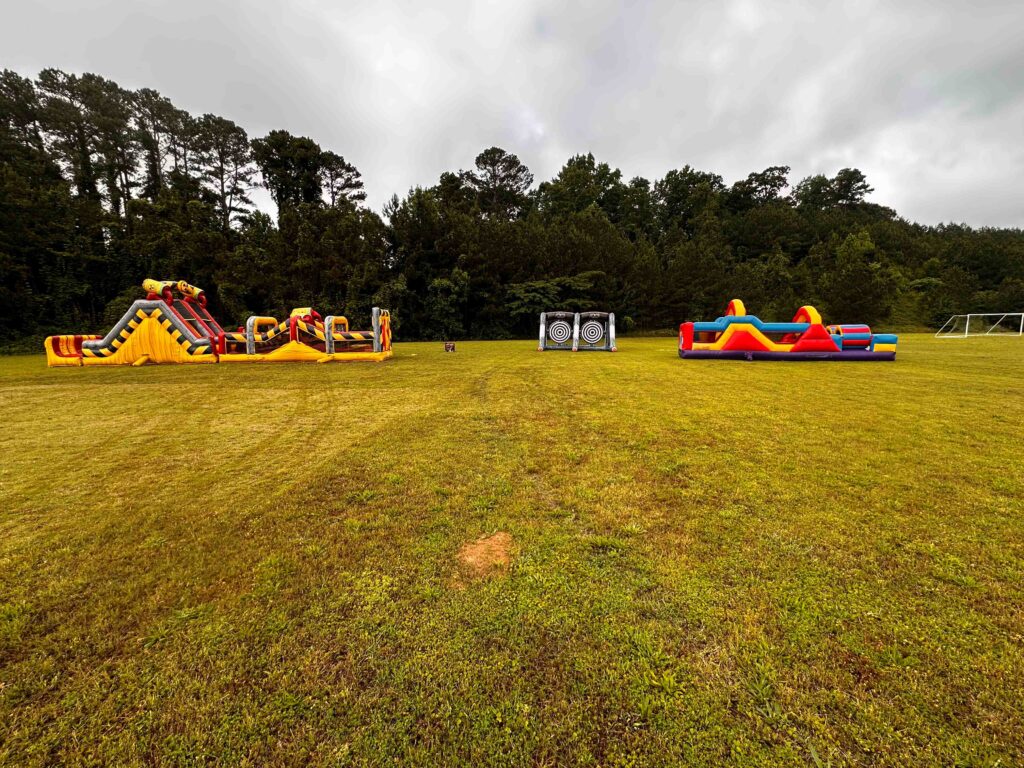 Families enjoying bounce house attractions at an outdoor event in Atlanta