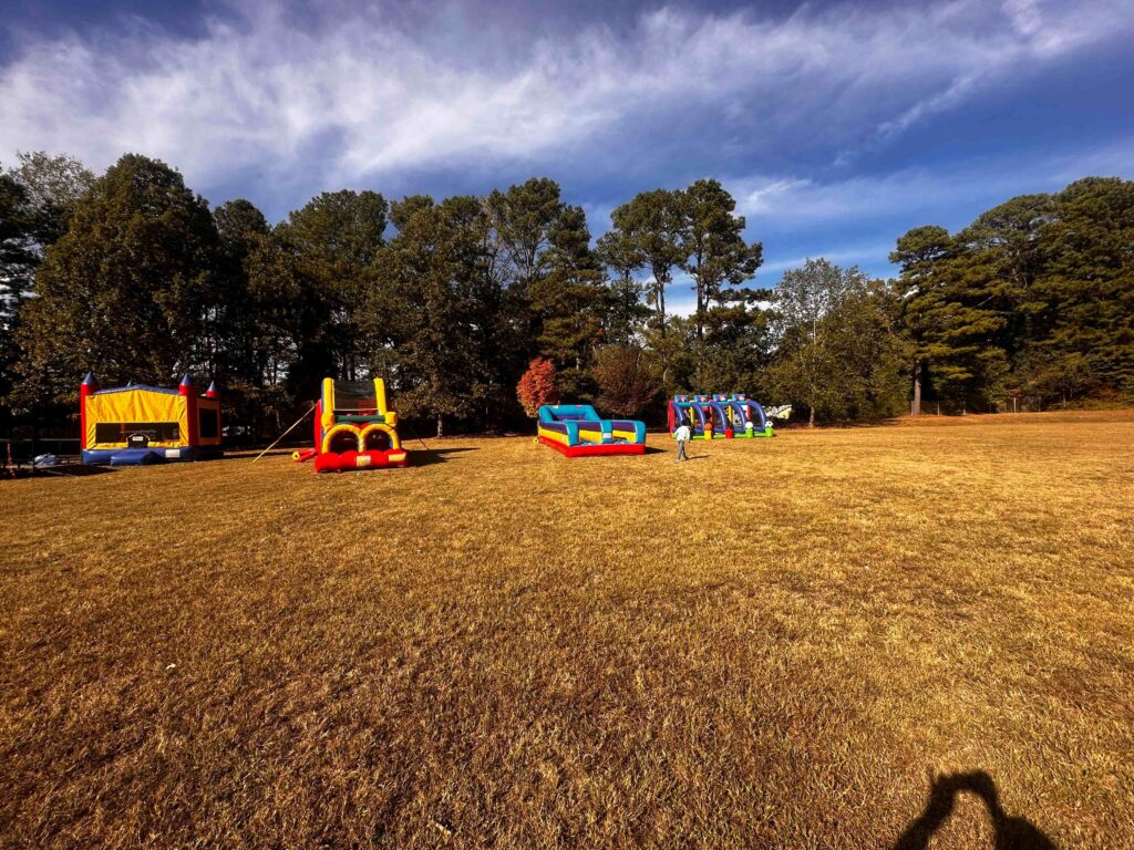 Large inflatable rentals setup at an outdoor wide grassy area Atlanta community event