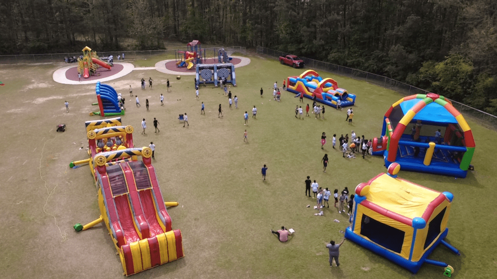 Colorful bounce houses and inflatables set up at an outdoor community event in Atlanta, Georgia